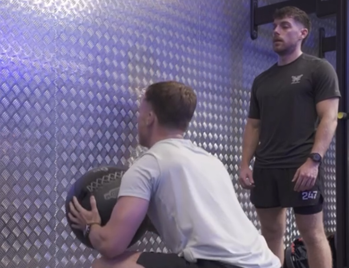 Tom Maguire coaching a client doing wall balls